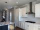 Stylish kitchen with modern white cabinets and stainless-steel appliances at 122 Stonehouse Dr, Cumming, GA 30040