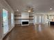 Expansive open-concept living room with hardwood floors, fireplace, and abundant natural light at 122 Stonehouse Dr, Cumming, GA 30040