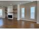 Spacious living room featuring hardwood floors and fireplace with shelves at 122 Stonehouse Dr, Cumming, GA 30040