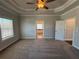 Spacious main bedroom featuring carpet flooring and doorways into the bathroom with standalone tub at 122 Stonehouse Dr, Cumming, GA 30040