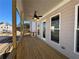 Covered porch with wood ceiling and flooring, providing a relaxing outdoor space at 122 Stonehouse Dr, Cumming, GA 30040