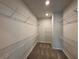 Spacious walk-in closet with multiple shelves and carpet flooring at 122 Stonehouse Dr, Cumming, GA 30040