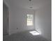 A bedroom with a single window at 2055 Ripple Park Bnd, Canton, GA 30114