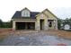 New construction home with a two-car garage, stone accents, and a welcoming front porch at 2055 Ripple Park Bend, Canton, GA 30114