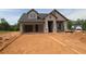 Charming new construction home with an open garage and stone detailing at 2055 Ripple Park Bnd, Canton, GA 30114