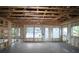 Open-concept interior with framed walls, large windows, and door to be completed at 2055 Ripple Park Bend, Canton, GA 30114