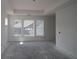 Living room featuring a tray ceiling and large windows at 2055 Ripple Park Bnd, Canton, GA 30114