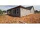 Side view of a house with stone foundation and large windows at 2055 Ripple Park Bnd, Canton, GA 30114