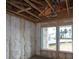 Unfinished room showing wooden frame, insulation and windows with outside view to customize to your taste at 2055 Ripple Park Bend, Canton, GA 30114