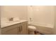 Bright bathroom features a modern vanity, toilet, and tiled bathtub with shower at 2055 Ripple Park Bnd, Canton, GA 30114