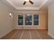 Bright bedroom with tray ceiling and three large windows offering plenty of natural light at 2055 Ripple Park Bnd, Canton, GA 30114