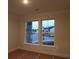 Bedroom with view of street and neighboring house through windows at 2055 Ripple Park Bnd, Canton, GA 30114
