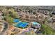 Aerial view showcases community amenities, tennis courts and pool, in a wooded neighborhood at 3149 Hidden Falls Ne Dr, Buford, GA 30519