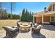 Inviting backyard patio with a stone fire pit and comfortable seating for outdoor gatherings at 3149 Hidden Falls Ne Dr, Buford, GA 30519