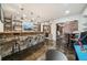 Finished basement featuring a stylish stone bar, comfortable seating, and a TV for entertainment at 3149 Hidden Falls Ne Dr, Buford, GA 30519
