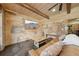 Cozy basement area with exposed brick, a comfortable couch, and rustic wooden accents at 3149 Hidden Falls Ne Dr, Buford, GA 30519