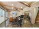 Finished basement with a seating area, bar, and wooden beams on the ceiling at 3149 Hidden Falls Ne Dr, Buford, GA 30519