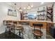 Finished basement bar area featuring a custom stone bar, shelving, and unique lighting fixtures at 3149 Hidden Falls Ne Dr, Buford, GA 30519