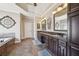 Elegant bathroom featuring a dual vanity with dark wood cabinets and a separate soaking tub at 3149 Hidden Falls Ne Dr, Buford, GA 30519
