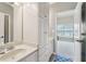 Bathroom with a single sink vanity, white cabinets, and an open view into the bedroom at 3149 Hidden Falls Ne Dr, Buford, GA 30519