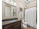 Full bathroom with granite counters, decoratively framed mirror, and shower-tub combo at 3149 Hidden Falls Ne Dr, Buford, GA 30519