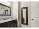Stylish bathroom featuring granite counters, ornate mirror, and a classic design at 3149 Hidden Falls Ne Dr, Buford, GA 30519