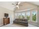 Bedroom with vaulted ceilings, fan and several windows providing natural light and backyard views at 3149 Hidden Falls Ne Dr, Buford, GA 30519