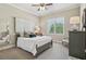 Bright bedroom with a ceiling fan, neutral colors, and large window views at 3149 Hidden Falls Ne Dr, Buford, GA 30519