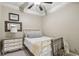 A bright bedroom features neutral walls and carpet, with a gray dresser and white bed frame at 3149 Hidden Falls Ne Dr, Buford, GA 30519