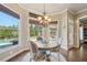 Cozy dining area with views of the pool, featuring a stylish chandelier and hardwood floors at 3149 Hidden Falls Ne Dr, Buford, GA 30519