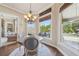 Casual dining area overlooking the backyard, featuring hardwood floors and a modern chandelier at 3149 Hidden Falls Ne Dr, Buford, GA 30519