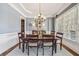 Traditional dining room with wainscoting, chandelier, and large window at 3149 Hidden Falls Ne Dr, Buford, GA 30519