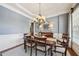 Charming dining room with classic chandelier, wainscoting, and inviting atmosphere at 3149 Hidden Falls Ne Dr, Buford, GA 30519
