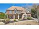 Inviting brick home with a covered porch, stone accents, and meticulously maintained landscaping at 3149 Hidden Falls Ne Dr, Buford, GA 30519