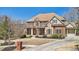 Charming two-story home with stone and brick facade, complemented by a lush lawn and driveway at 3149 Hidden Falls Ne Dr, Buford, GA 30519