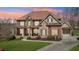 Beautiful brick and stone two-story home with a covered porch, manicured lawn, and a curved driveway at 3149 Hidden Falls Ne Dr, Buford, GA 30519