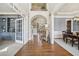 Elegant foyer with hardwood floors, arched doorways, and stylish built-in shelving at 3149 Hidden Falls Ne Dr, Buford, GA 30519
