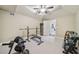 Home gym with weightlifting equipment, a ceiling fan, a mirror, and a connection to a home office at 3149 Hidden Falls Ne Dr, Buford, GA 30519