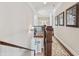 Hallway with hardwood floors, light walls and decorative area rug leading to bedrooms at 3149 Hidden Falls Ne Dr, Buford, GA 30519