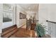 Hallway with hardwood floors, wood banister and wrought iron spindles overlooking open spaces at 3149 Hidden Falls Ne Dr, Buford, GA 30519