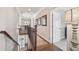 Upstairs hallway with hardwood floors, natural light, and stylish architectural details at 3149 Hidden Falls Ne Dr, Buford, GA 30519