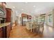 Open kitchen with stainless appliances, wooden cabinetry, and dining area at 3149 Hidden Falls Ne Dr, Buford, GA 30519