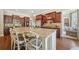Spacious kitchen features granite countertops, wooden cabinetry, and a center island with barstool seating at 3149 Hidden Falls Ne Dr, Buford, GA 30519