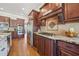 Gourmet kitchen includes stainless steel appliances, dark wood cabinets, tile backsplash, and granite countertops at 3149 Hidden Falls Ne Dr, Buford, GA 30519