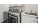 Convenient laundry room with modern stainless steel washer, dryer, and sink at 3149 Hidden Falls Ne Dr, Buford, GA 30519