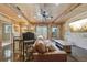 Comfortable living room with exposed brick wall, wooden beams, and concrete floors at 3149 Hidden Falls Ne Dr, Buford, GA 30519