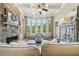 Bright living room with stone fireplace, coffered ceiling, and expansive bay windows at 3149 Hidden Falls Ne Dr, Buford, GA 30519