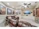 A cozy media room features a leather sectional, a ceiling fan, and a large television at 3149 Hidden Falls Ne Dr, Buford, GA 30519