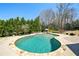 Expansive backyard pool and patio with outdoor kitchen, lush landscaping, and seating areas at 3149 Hidden Falls Ne Dr, Buford, GA 30519