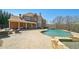 A spacious pool area with a tanning ledge, a stone waterfall feature, and ample space for entertaining at 3149 Hidden Falls Ne Dr, Buford, GA 30519